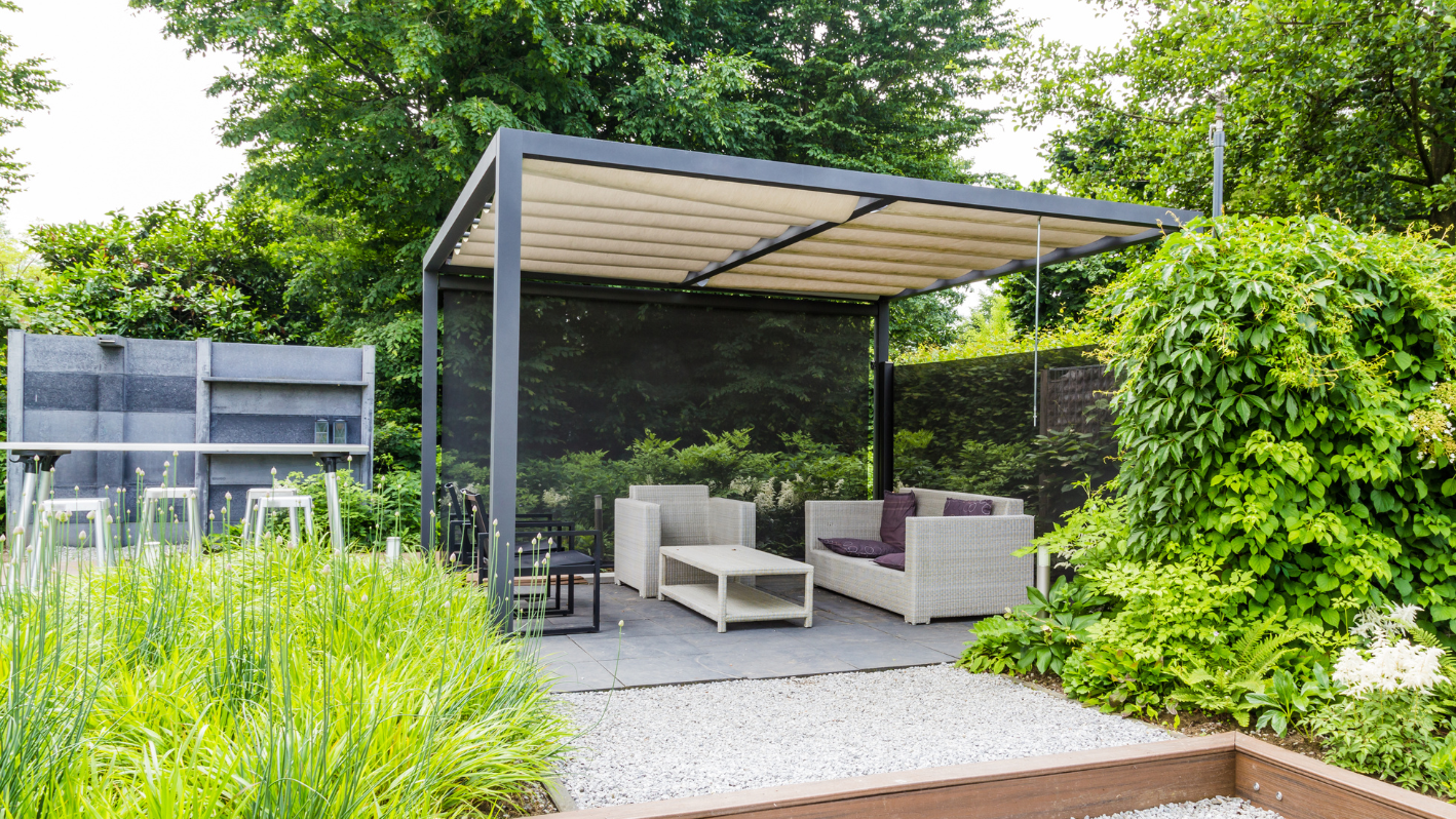 A covered patio with a table and chairs